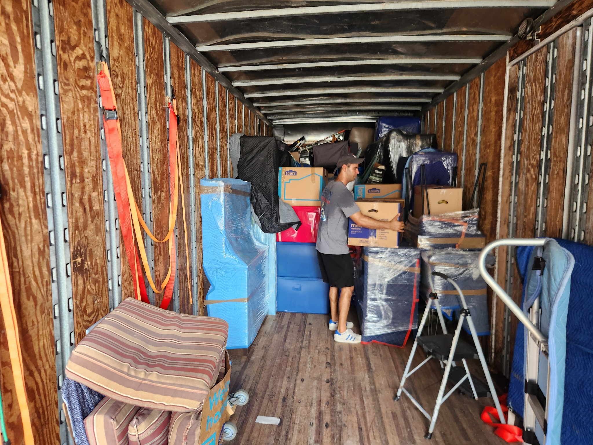 Triton Moving crew organizing furniture and boxes inside the moving truck