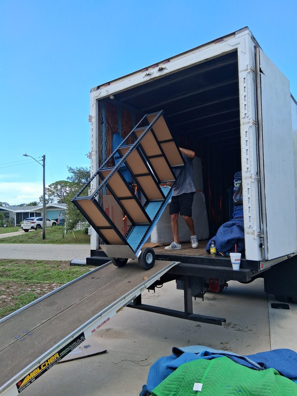 Triton Moving crew safely unloading a large shelving unit