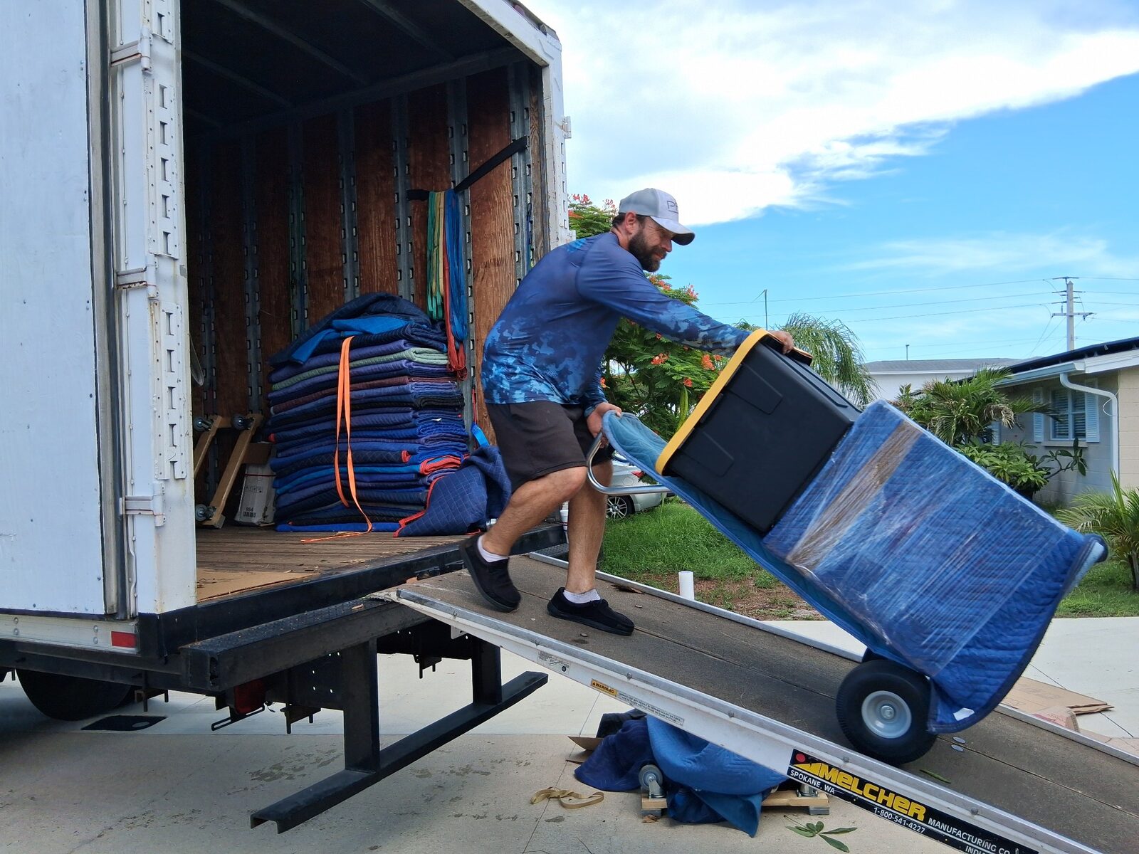 Triton Moving professional unloading protected furniture from the moving truck