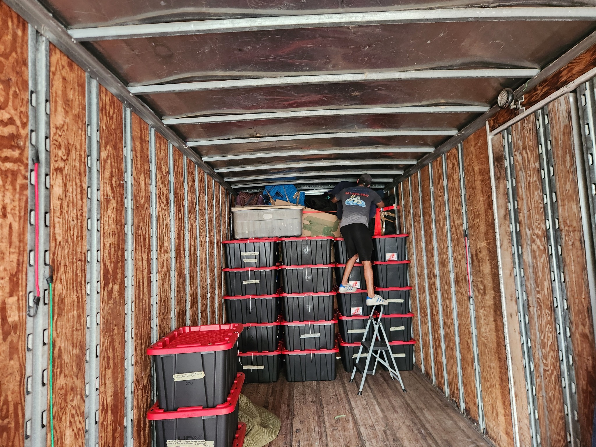 Organized storage bins secured inside the Triton Moving truck