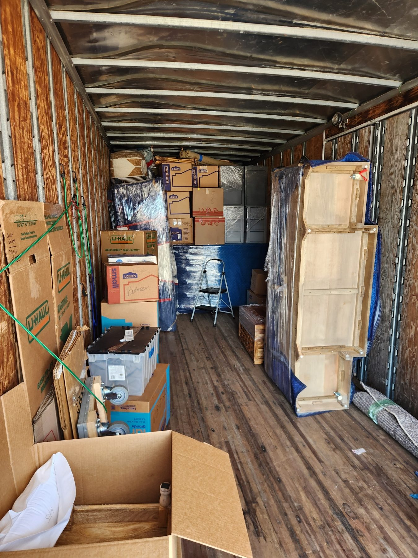 Organized truck loading with furniture pads and shrink wrap